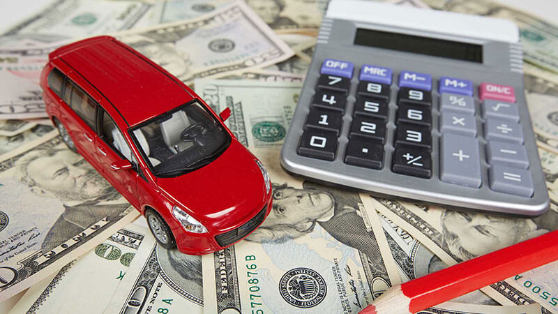 cash, car, calculator and red pencil
