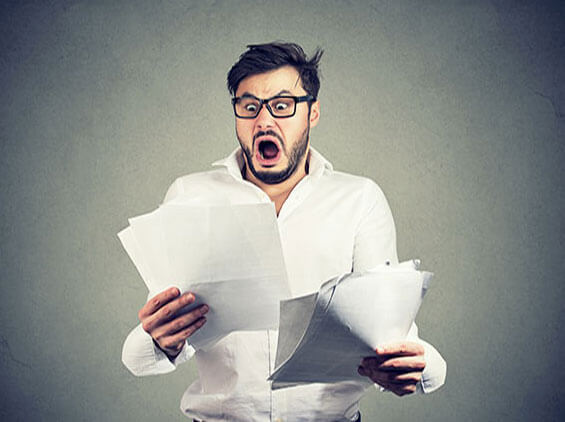 shocked looking guy looking a paperwork